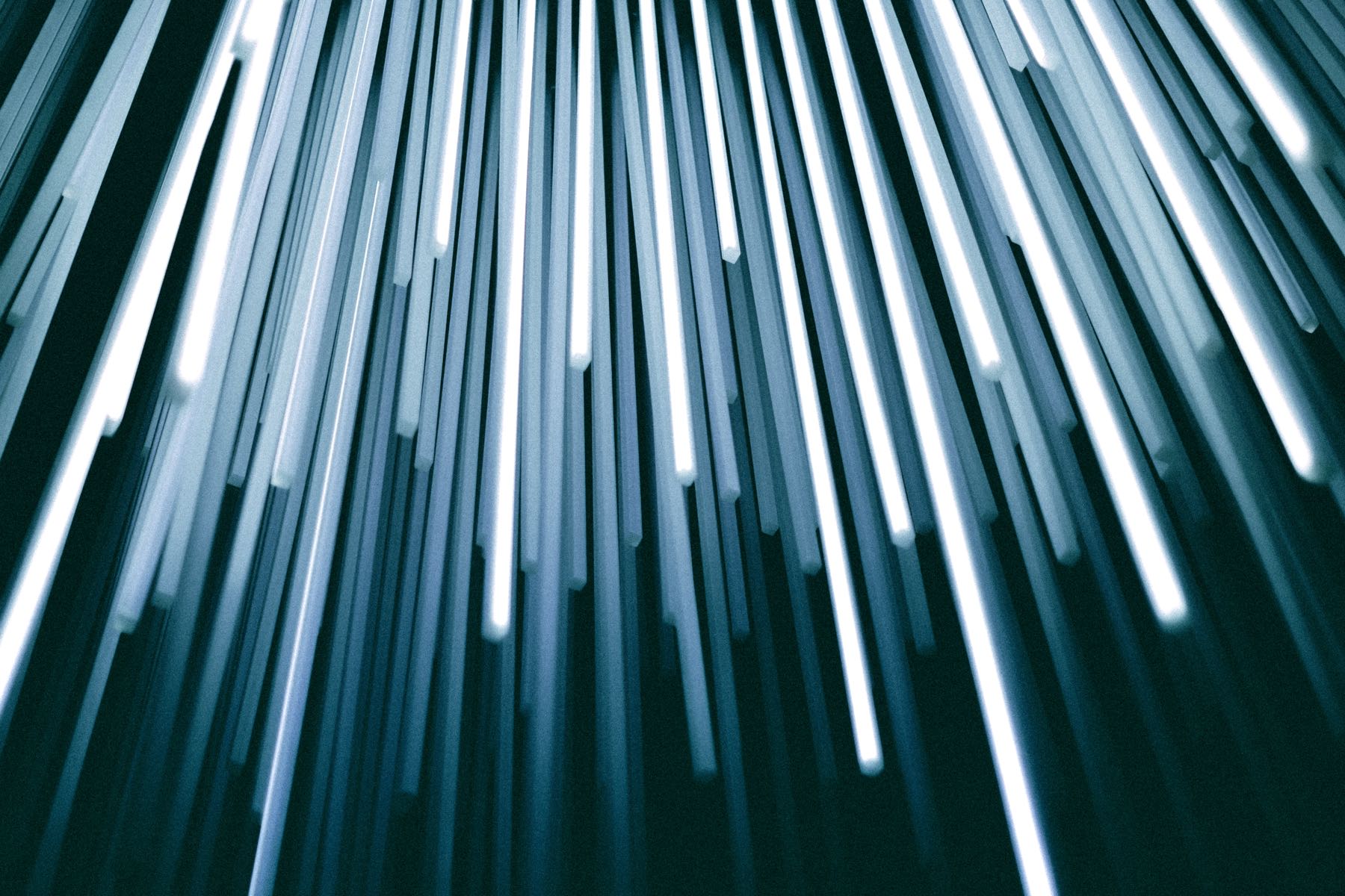 Abstract macro of illuminated fibre-optic strands in cool blue light